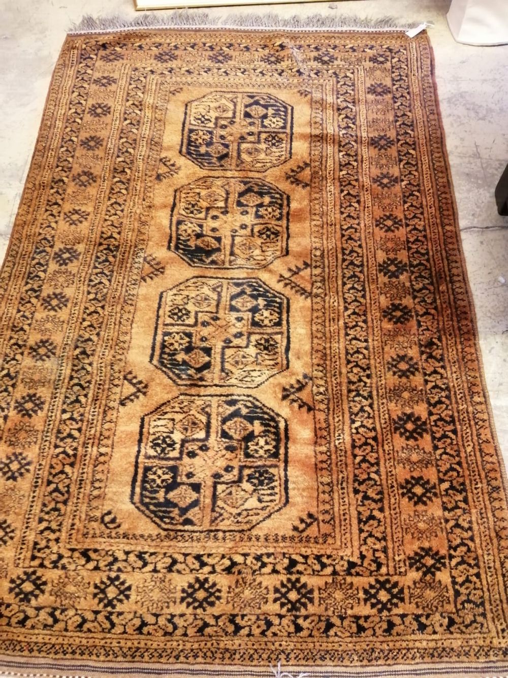 An Afghan rust ground rug, 207 x 131cm